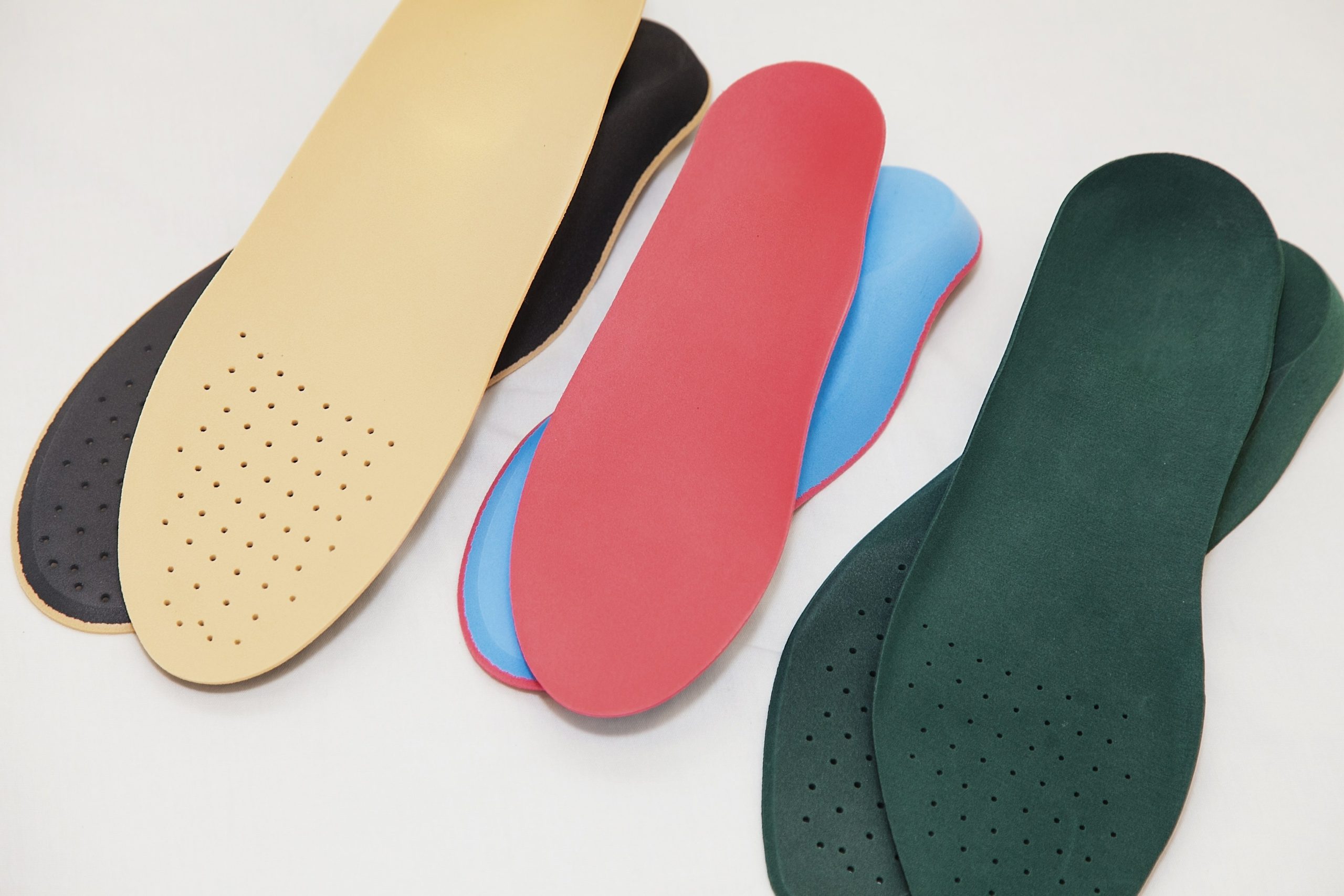 Different types of inserts for shoes, including over-the-counter and prescribed orthotics, for foot support and cushioning.