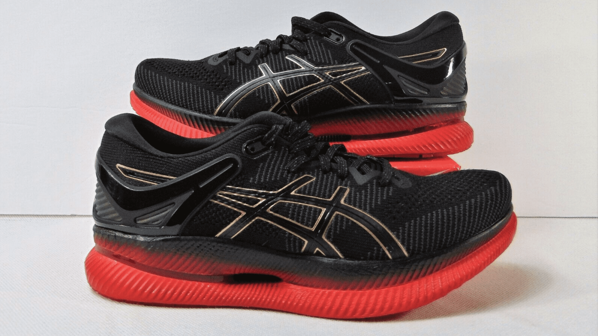 A pair of Asics Metaride shoes, highlighting the rocker sole and ample room for toes that make them suitable for relieving pain associated with hammer toes.