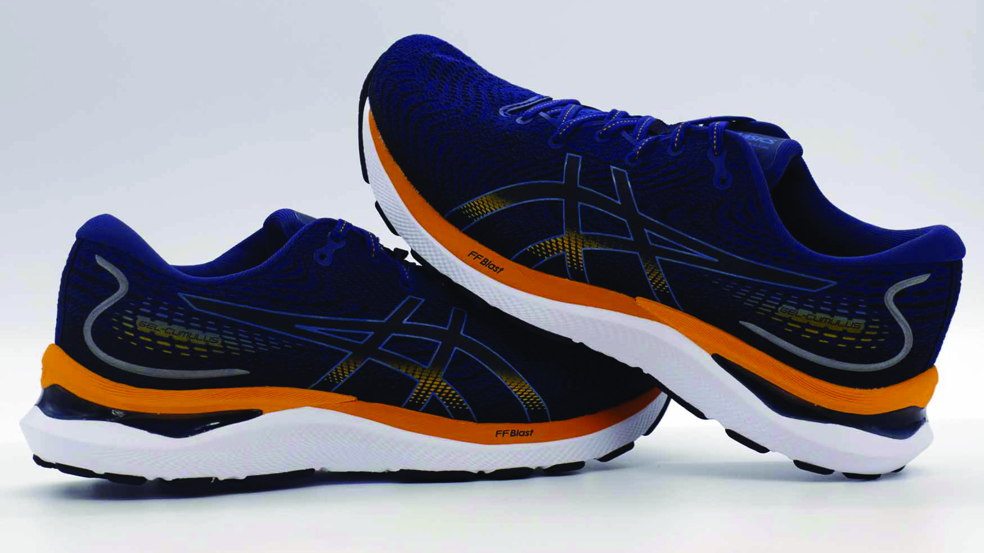 A pair of Asics Gel Cumulus 24 running shoes, designed with gel cushioning systems that absorb shock and promote proper foot alignment, perfect for improving posture and reducing knee pain as recommended by shoefit.uk.