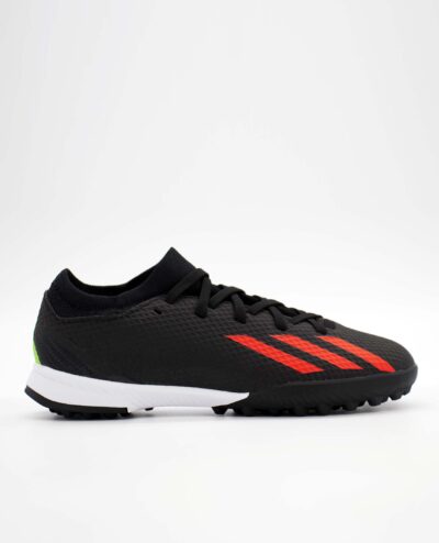 A side view of the Adidas X Speedportal.3 Turf, in Core Black/Solar Red/Solar Green.