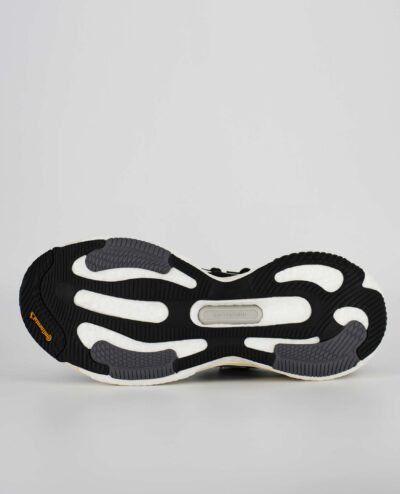 An underside view of the Adidas Solarglide 6, in Core Black/Cloud White/Grey Two.
