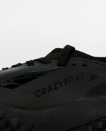 An extreme close-up of the Adidas X Crazyfast.3 Firm Ground, in Core Black/Core Black/Core Black.