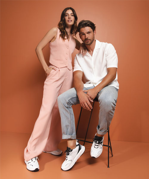 A man and a woman modelling Xsensible footwear.
