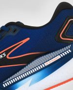 An extreme close-up of the Brooks Glycerin GTS 21, in Blue Opal/Black/Nasturtium.