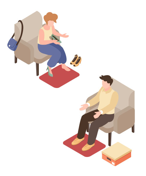 A man and a woman sitting on sofas, trying on different footwear.