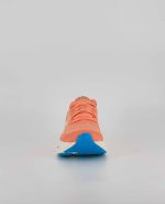 The front of the Brooks Ghost Max, in Papaya/Apricot/Blue.
